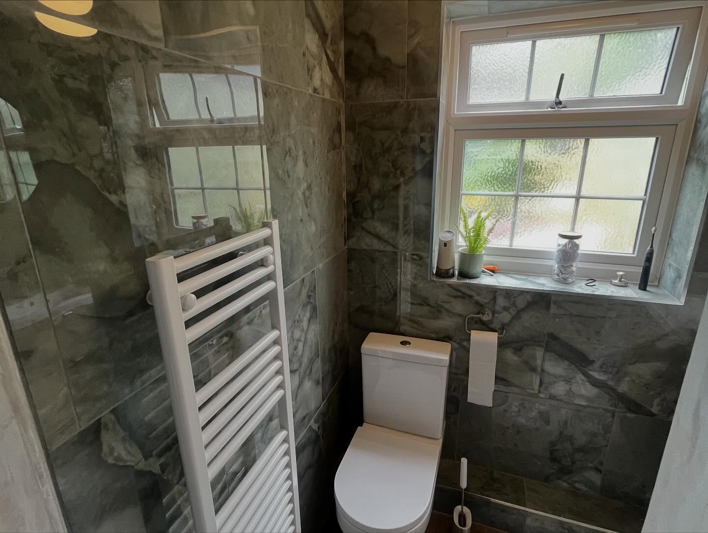 Fully tiled family bathroom with heated towel rail