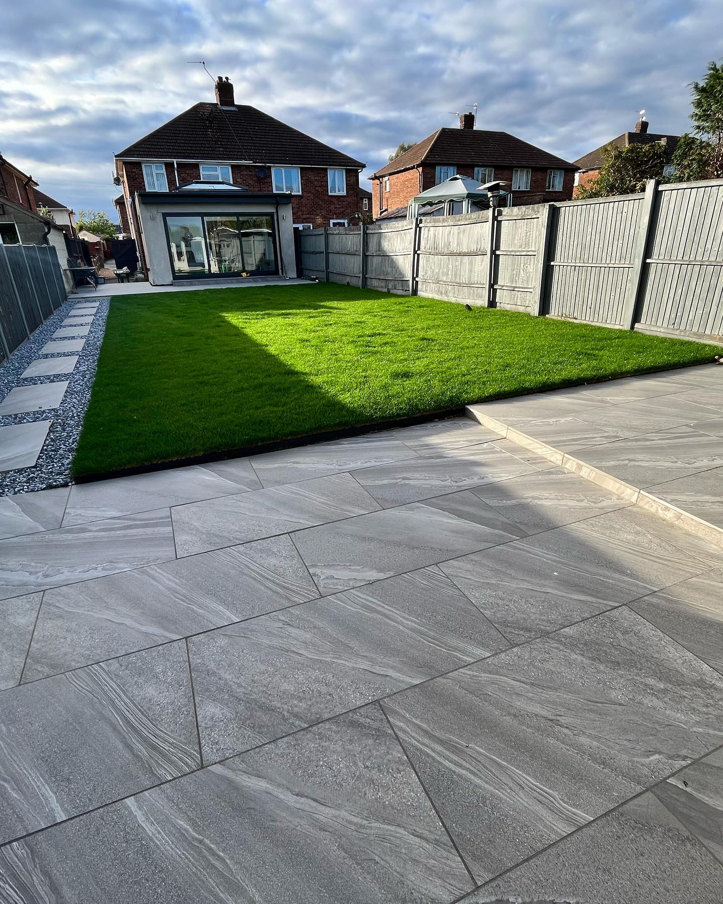 Landscaped rear garden with large-format patio and lawn