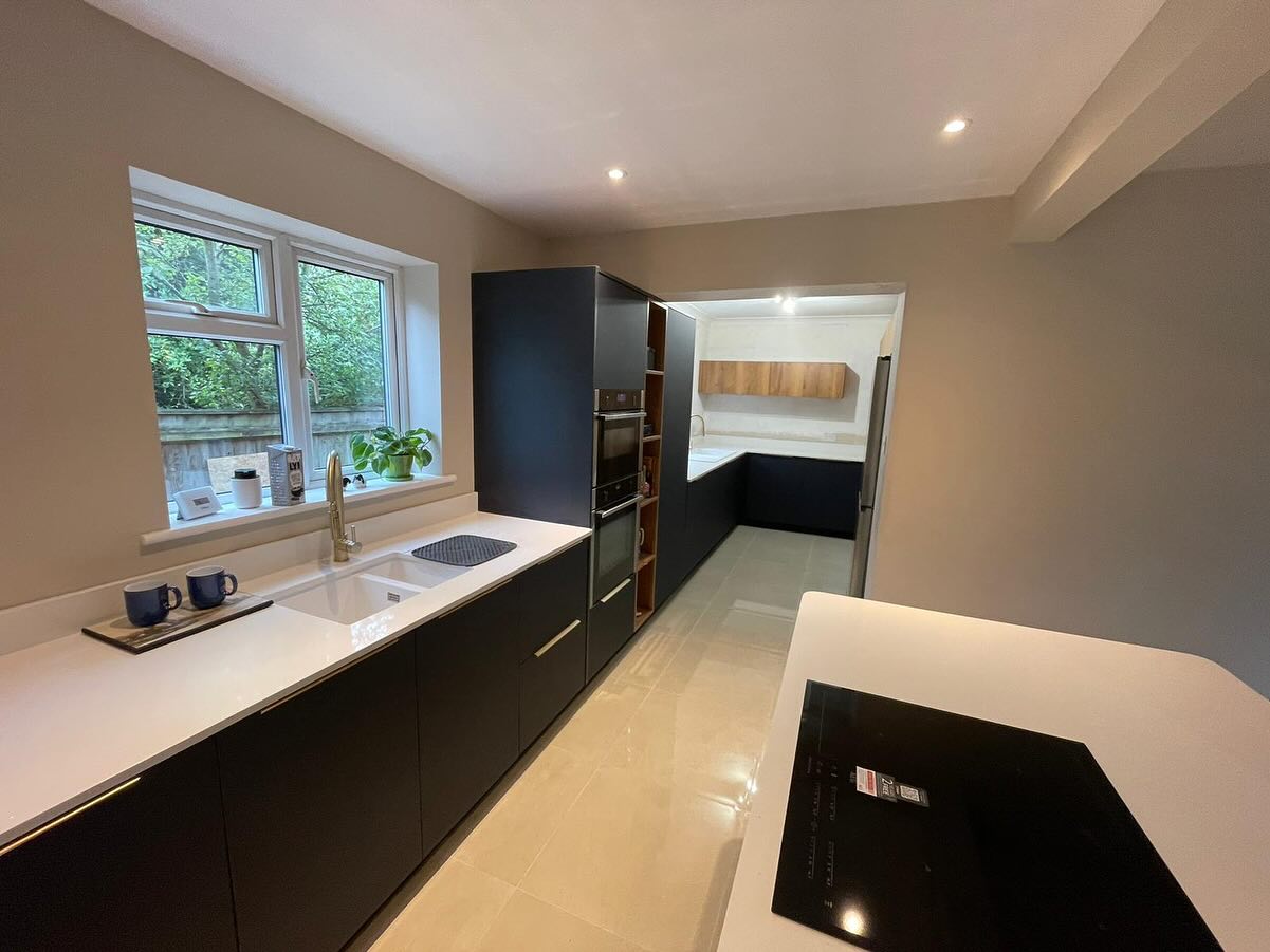 White kitchen with stepped ceiling bulkhead and downlights